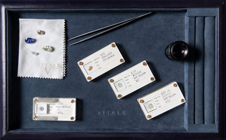 Natural coloured and colourless diamonds displayed with gemological tools at VITALE 1913 in Monaco.